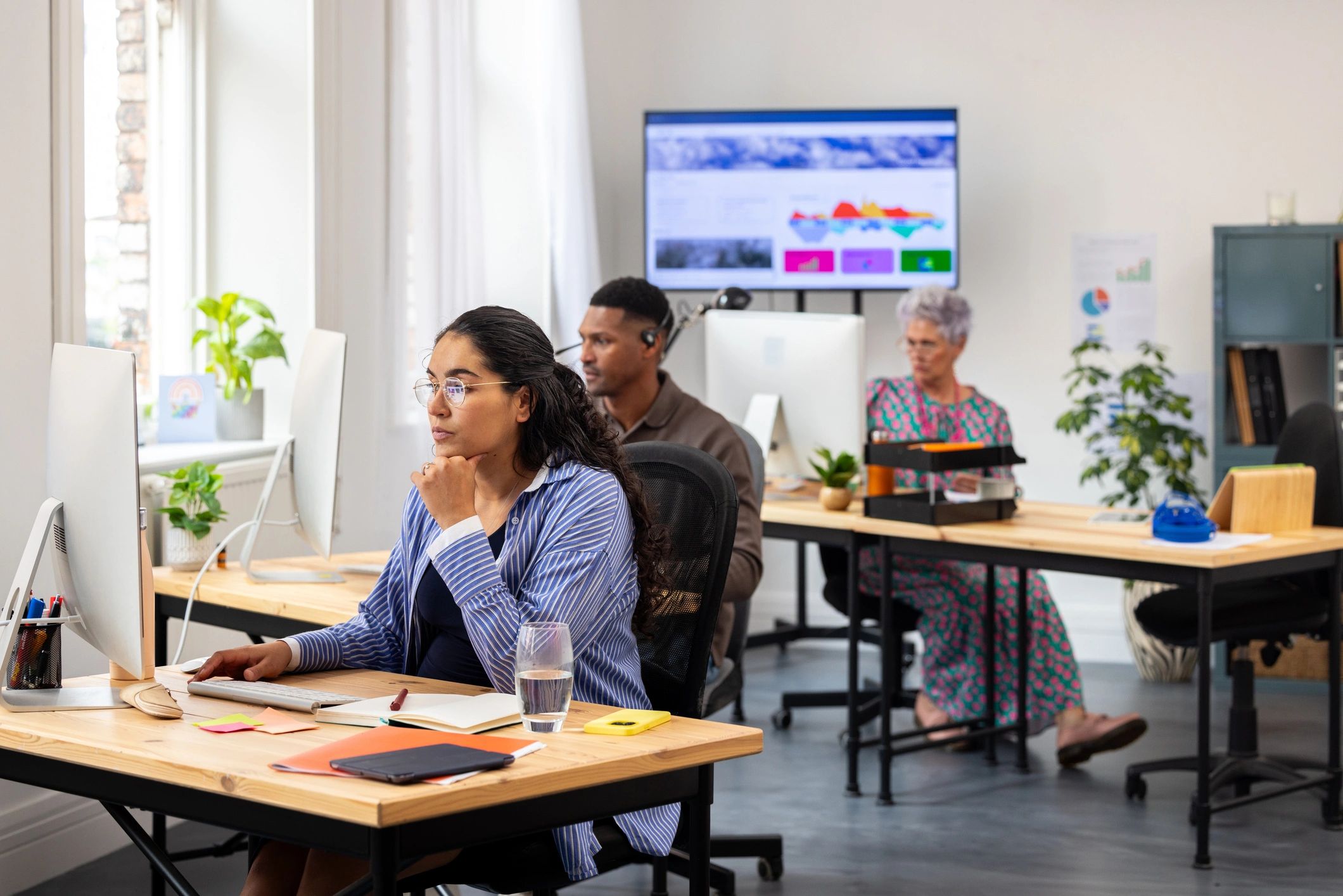 Analysts monitoring performance data in a modern office