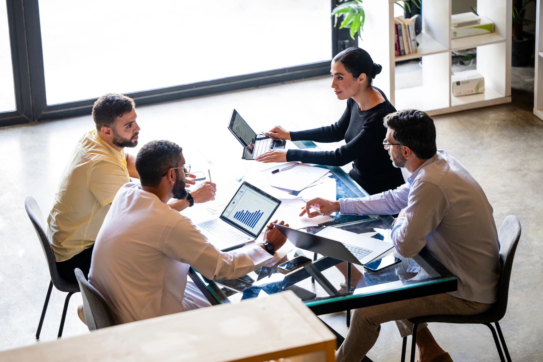 Consulting team reviewing performance dashboards in a modern meeting room